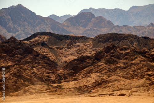 Photography Layered desert mountains under bright daylight showing vast dry landscape and pe