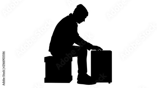 Silhouette of man sitting on suitcase white background.