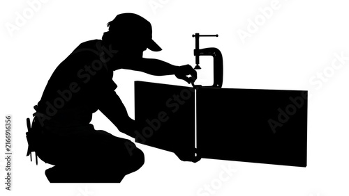 Silhouette of worker using tool on white background.