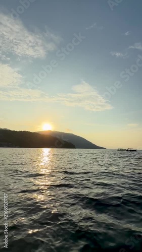 Boat riding in Iboih, Sabang, Indonesia. Serene boat ride on calm waters during a vibrant sunset