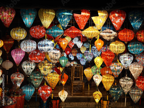 Colorful traditional Vietnamese lanterns arranged around a chair at a popular photography spot in Hoi An Ancient Town, Vietnam.