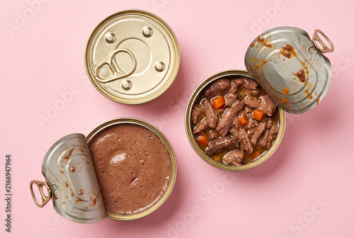Variety of Opened Pet Food Cans on Pink Background for Commercial Use