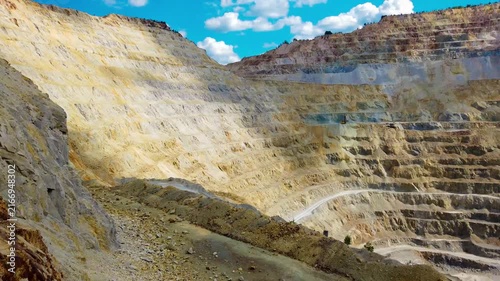 Aerial view of massive open pit copper mine at Rosia Poieni in Alba County, Romania. Massive Terraced Open Pit Mine in the Apuseni Mountains. Human Impact on Nature, Giant Stepped Terraces of Surface 