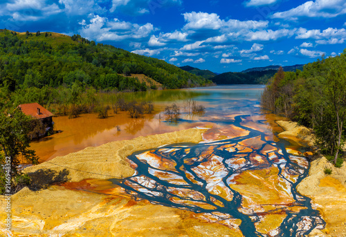 Spectacular, extremely toxic colors on the surface of the Geamana tailings pond appear due to chemical oxidation-reduction processes of minerals and heavy metals spilled from the copper mining