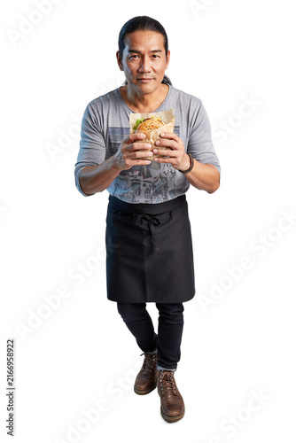 Asian man holding a burger in paper wrapper isolated on a transparent background