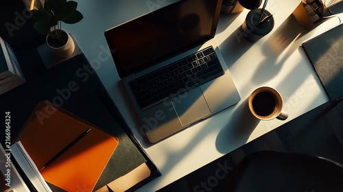 Overhead view of a modern workspace with laptop and coffee break