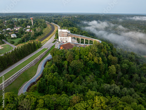 Photography Aerial view of bobsleigh and luge track surrounded by forest and morning mist in