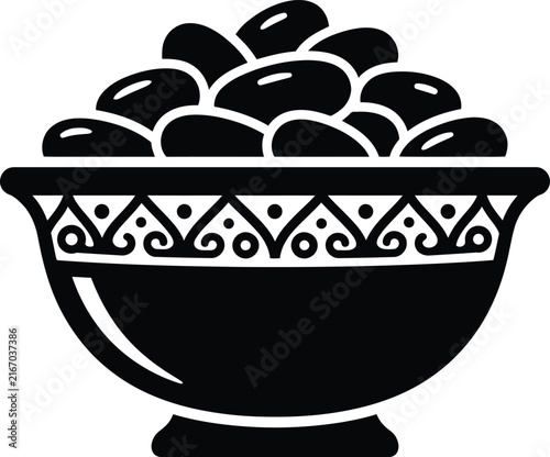Black Islamic bowl of dates with ornate arabesque pattern decoration
