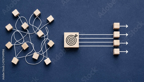Tangled White Strings With Scattered Wooden Blocks Converging Through a Target Cube and Emerging as Straight Arrows and Aligned Cubes Representing Process Streamlining and Strategic Business Alignment