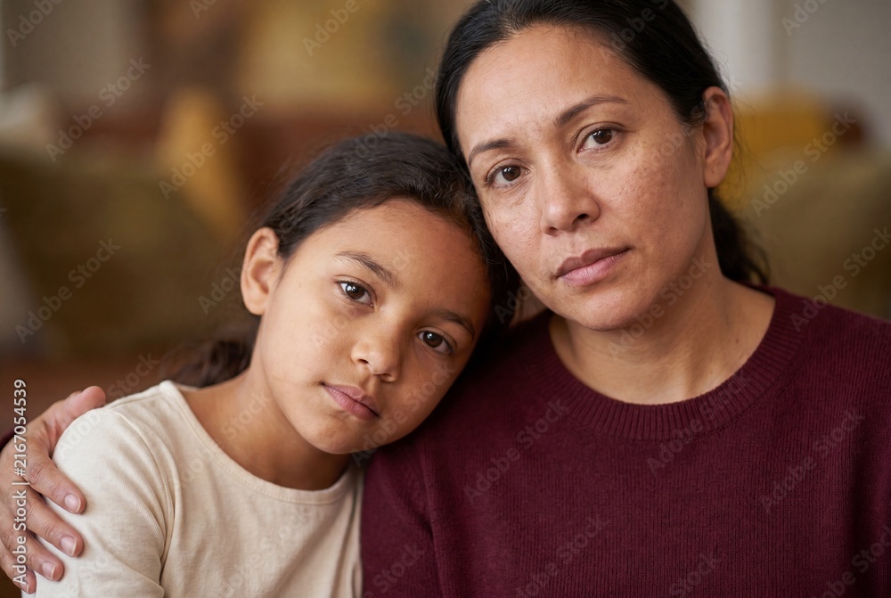 Obraz premium Emotive Portrait of Mother Offering Support to Concerned Young Child