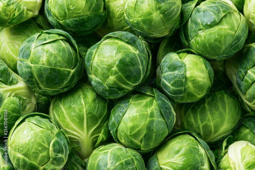 Fototapeta premium Fresh brussels sprouts arranged closely together in a market setting