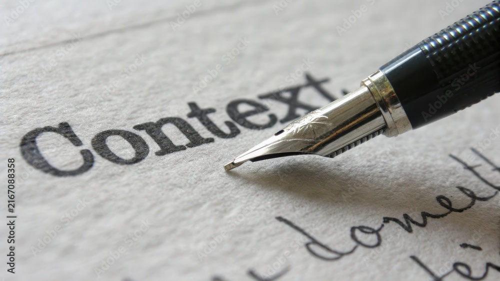 Fototapeta premium Close-Up of Fountain Pen on Paper with Word Context in Focus