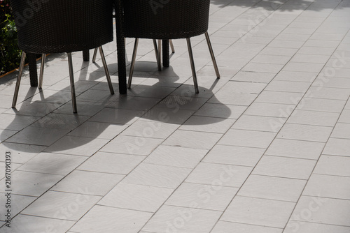 Outdoor Terrace Floor with Wicker Chair Shadows in Sunlight