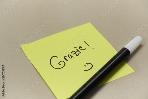 Fotografie Handwritten Grazie Thank You text in Italian on yellow sticky note with marker p