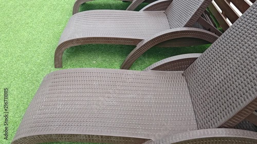 Empty Woven Lounge Chair at Poolside