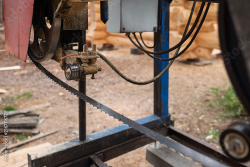 Close-up of machine for sawing pine logs at sawmill