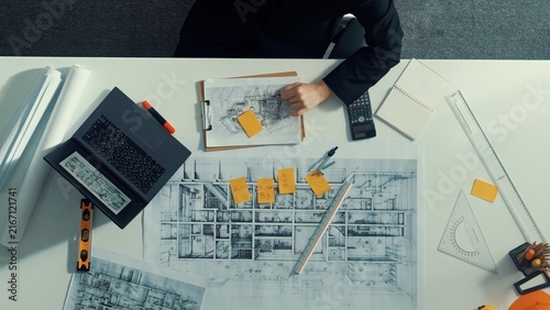 Fotografie Time lapse of smart architect drawing while working at laptop
