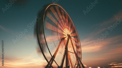 Nighttime Ferris wheel spinning in amusement park
