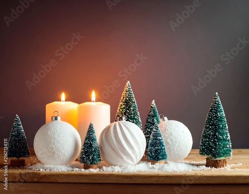 White candles with ornaments and mini trees.