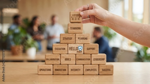 Stack of cardboard boxes with hello sticker on wooden floor