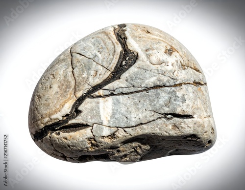 Grey river stone showing layered mineral veins.