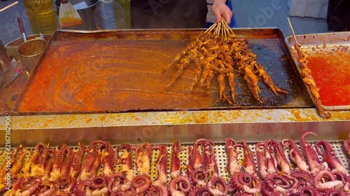 Korean Street Food – Grilling Squid and Octopus Skewers in Spicy Red Sauce at Outdoor Market Stall