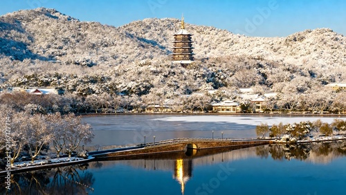 Snow-covered landscape with pagoda and lake reflection