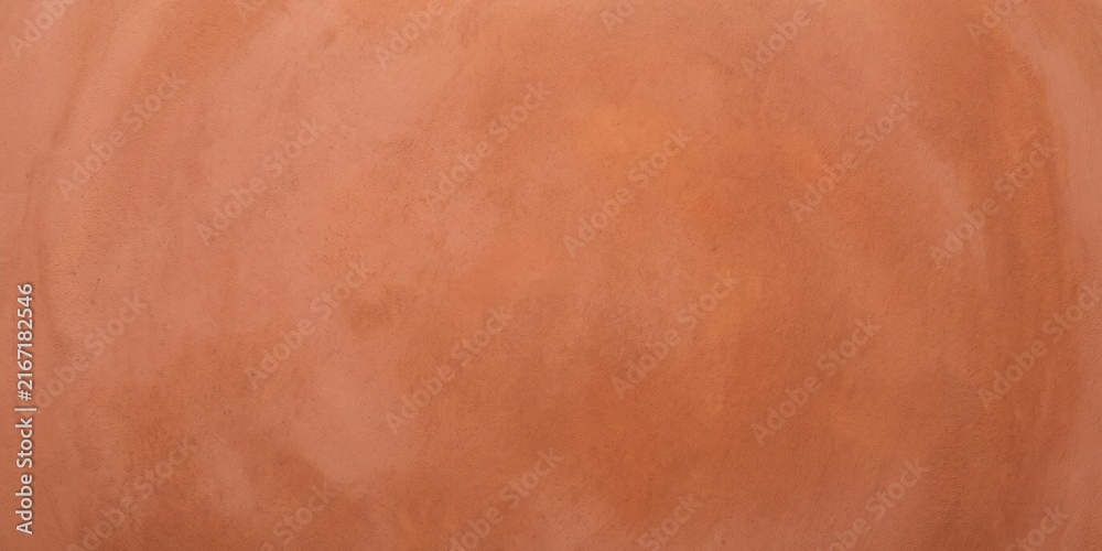 Fototapeta premium terracotta plaster texture background, warm orange clay wall surface with subtle grain, minimalist rustic plaster backdrop for interior design.