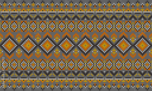 Traditional cross stitch geometric pattern in orange and yellow on gray background.