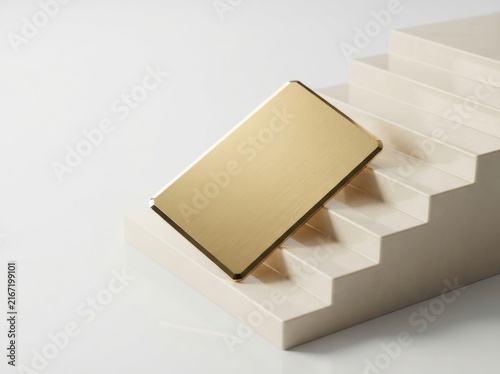 Gold luxury credit card resting on white marble steps for premium finance branding