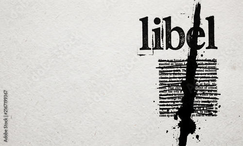 The word libel printed on a page with a thick black ink streak obscuring the text