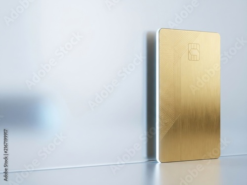 Vertical gold credit card standing on a clean white surface for banking and finance concepts.