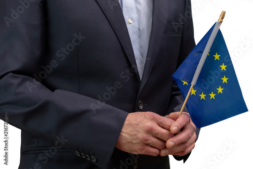 Canvas Print Businessman holding European Union flag isolated on white background closeup
