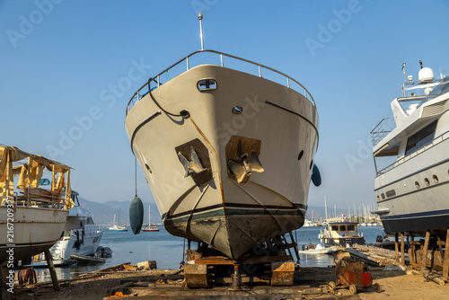 Fotografie Large yacht under repair and maintenance on a dry dock shipyard by the sea