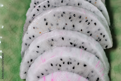 Картината върху платно White dragon fruit slice with black seed, pink flesh, and moist texture arranged