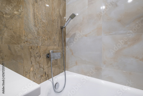  details of corner with water tap sink with faucet with soap and shampoo dispensers in expensive bathroom in rustic eco style