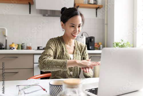 Fotografía Asian female sign language user working remotely using laptop and online video c