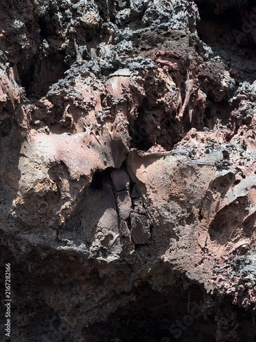 Yaiza, Spain - June 28, 2026: Volcanic rock surface displaying unique textures and colors, featuring shades of gray, pink, and brown in a natural environment