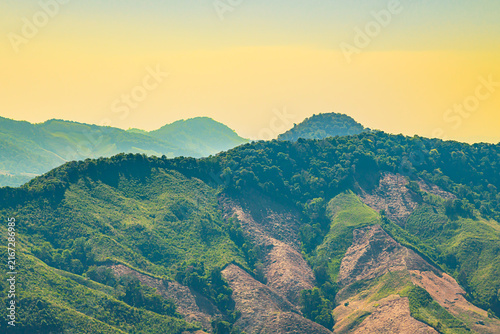 Deforestation and Environmental Change Series : Scenic green canopy juxtaposed with cleared slopes in Nan Thailand highlights aggressive land use change.