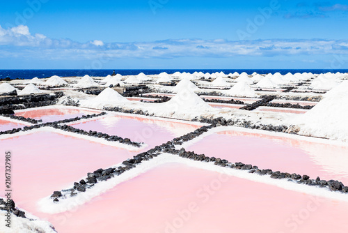 Mounds of sea salt beside pink evaporation ponds at Salinas de Fuencaliente La Palma