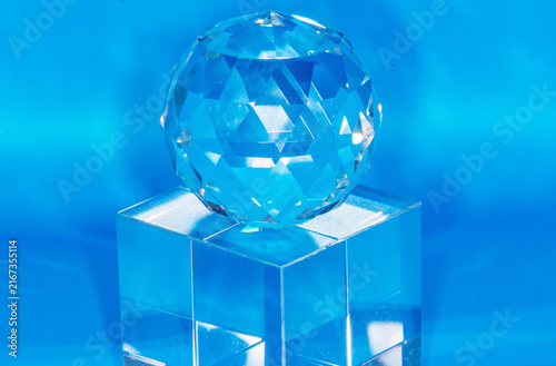 blue crystal glass sphere on top of a cube