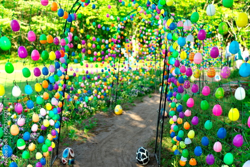 Colorful Easter egg tunnel decoration in park garden
