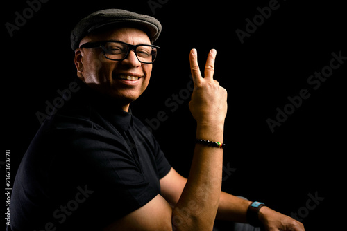 Bild auf Leinwand Handsome black man wearing glasses and a newsboy hat