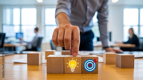 Business professional choosing between ideas and goals using wooden blocks
