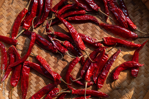 Dried chili peppers on traditional indonesian woven bamboo basket (besek), prepared to make sambal (spicy sauce), chili oil, or other hot dishes