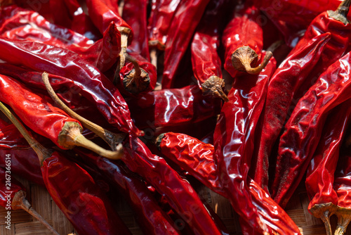 Dried chili peppers on traditional indonesian woven bamboo basket (besek), prepared to make sambal (spicy sauce), chili oil, or other hot dishes