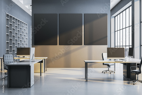 Modern corporate office interior with three blank vertical wall frames, desks, computers, shelving, and bright windows for business mockup design. 3D Rendering