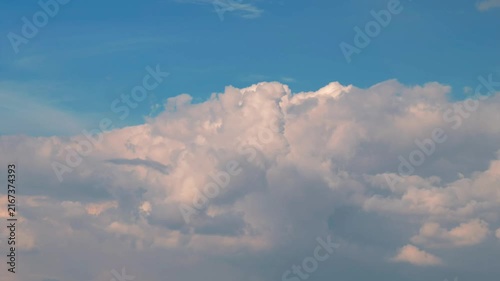 White puffy clouds drifting across a bright blue sky during a sunny afternoon capturing nature in motion