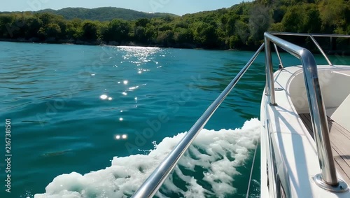 Exquisite 4K luxury travel clip showing glittering ocean water droplets splashing dynamically off the edge of a moving speed boat during a refreshing tropical summer vacation cruise