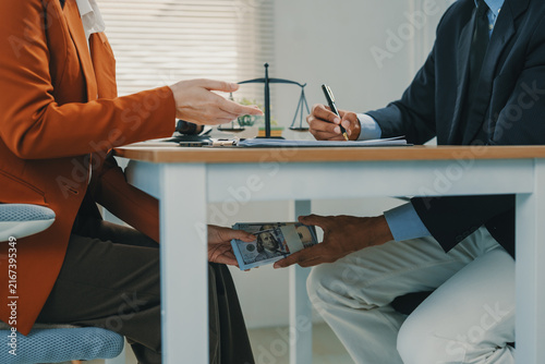 Canvas Print Person secretly passing money under table for bribery
